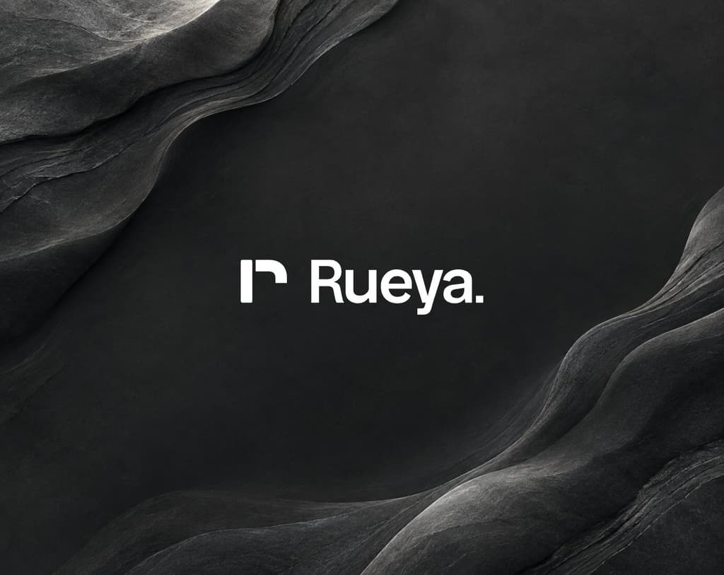 The Rueya wordmark in white beside the r mark, on dark layered stone